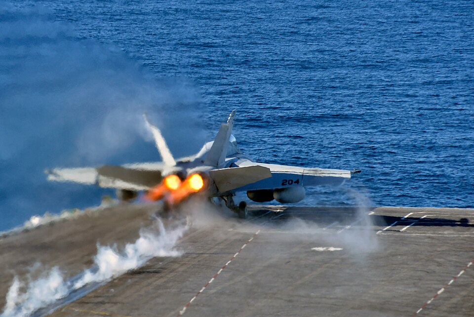 A US Navy F/A-18E Super Hornet, the jet the F/A-XX is meant to replace, launching with its afterburners lit from the flight deck of the aircraft carrier USS Nimitz in the Pacific in November 2016