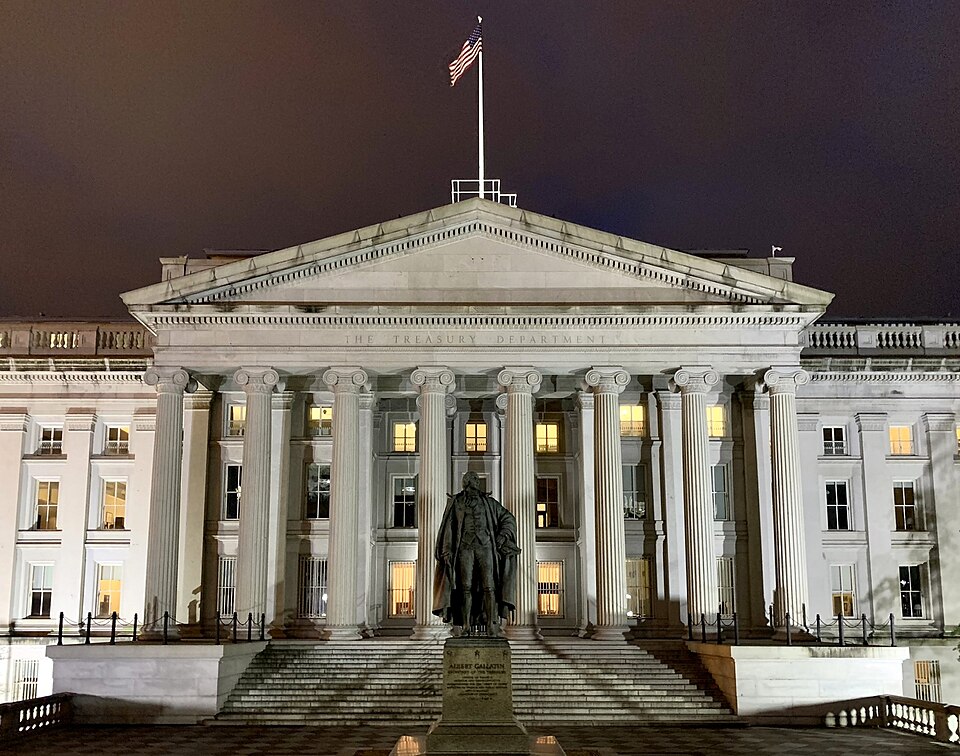 The Treasury Building in Washington at night, with the statue of Albert Gallatin in the foreground, photographed in January 2023