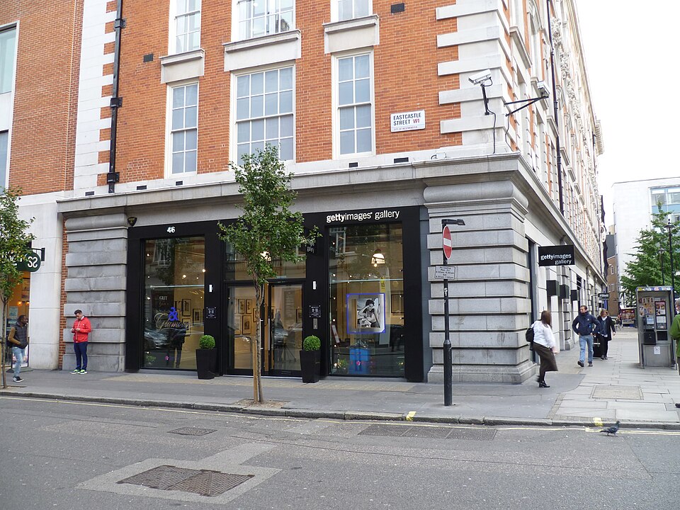 The Getty Images Gallery at 46 Eastcastle Street, London: a brick and stone corner building with a black shopfront signed gettyimages gallery, a matching hanging sign and the Eastcastle Street W1 stre