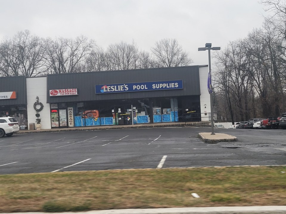 A Leslie's Pool Supplies store in a strip mall in Green Brook, New Jersey, seen across a nearly empty parking lot on a grey winter day in January 2022