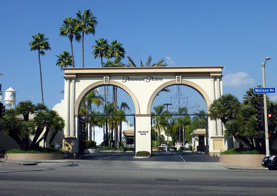 The Melrose Gate of the Paramount Pictures lot in Hollywood, Los Angeles, in October 2014: a cream double arch with the studio's name above it and palm trees behind