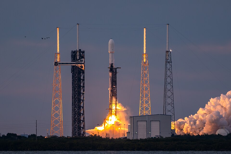 A SpaceX Falcon 9 rocket carrying 23 Starlink satellites lifts off at dusk between lightning towers at Space Launch Complex 40, Cape Canaveral Space Force Station, Florida, on 10 March 2024