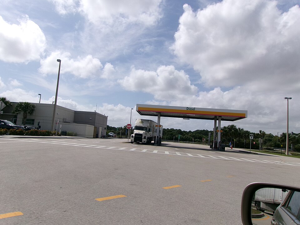 A tractor-trailer at the diesel pumps under a canopy marked Diesel at the Fort Pierce service plaza on Florida's Turnpike, March 2025