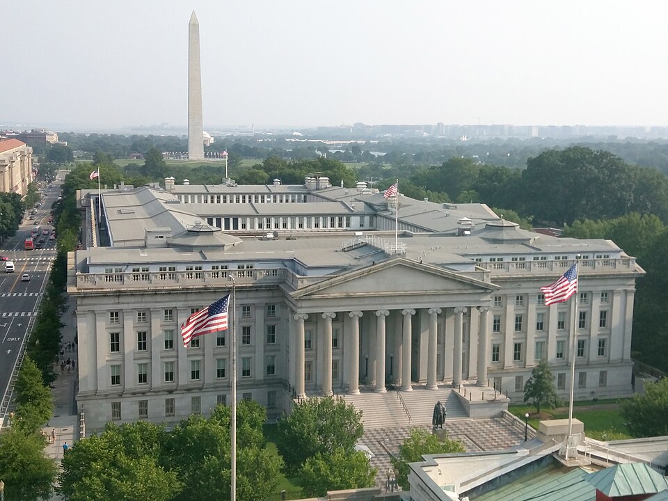 The Treasury Building in Washington, with the Washington Monument behind it, photographed in July 2015