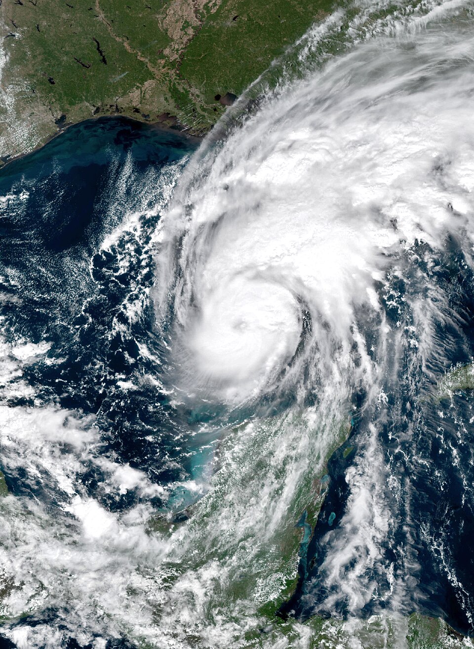 Hurricane Isaias seen from NOAA's GOES-19 satellite on the afternoon of Thursday 8 October 2026: a tight white spiral of cloud over the dark blue Gulf, its bands reaching north over the coast, with th
